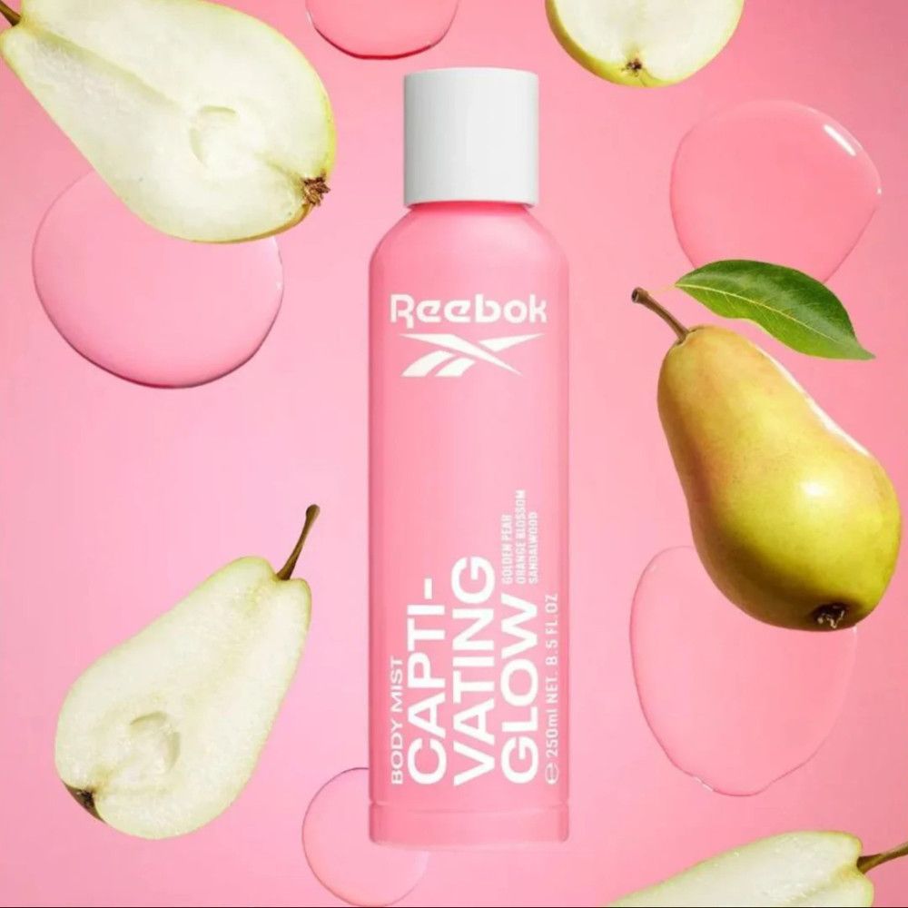 Rosa Körperspray-Flasche mit weißem Deckel. Reebok-Logo und Schriftzug "CAPTIVATING GLOW". Birnen und rosa Tropfen.