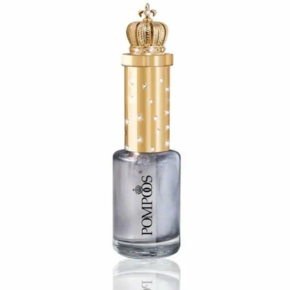 Nagellackflasche mit silbernem Inhalt, goldener Kappe mit Krone und Strasssteinen. Aufschrift "Pompöös".