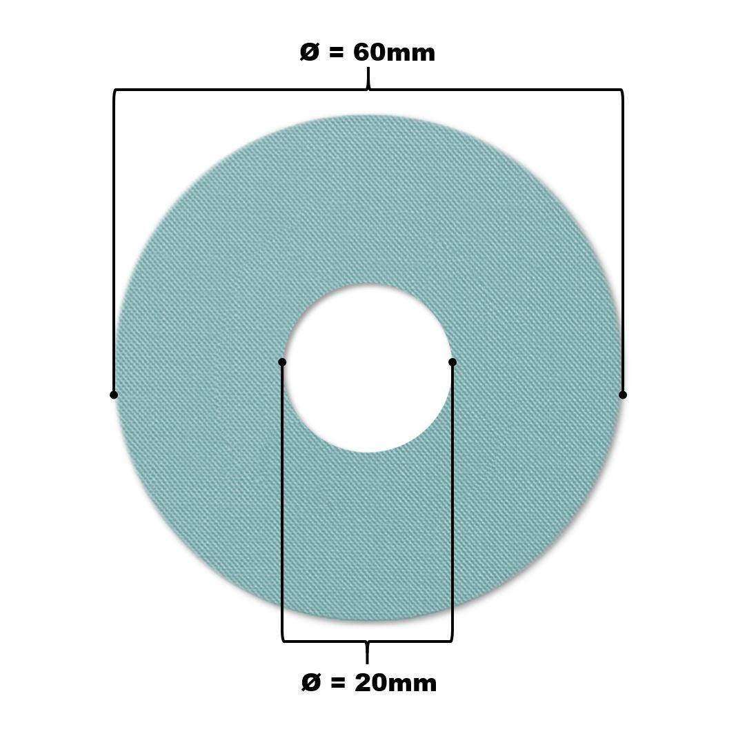 Hellblauer Katheterpatch mit zentralem Loch. Durchmesser 60mm, Loch 20mm. Gewebte Textur.