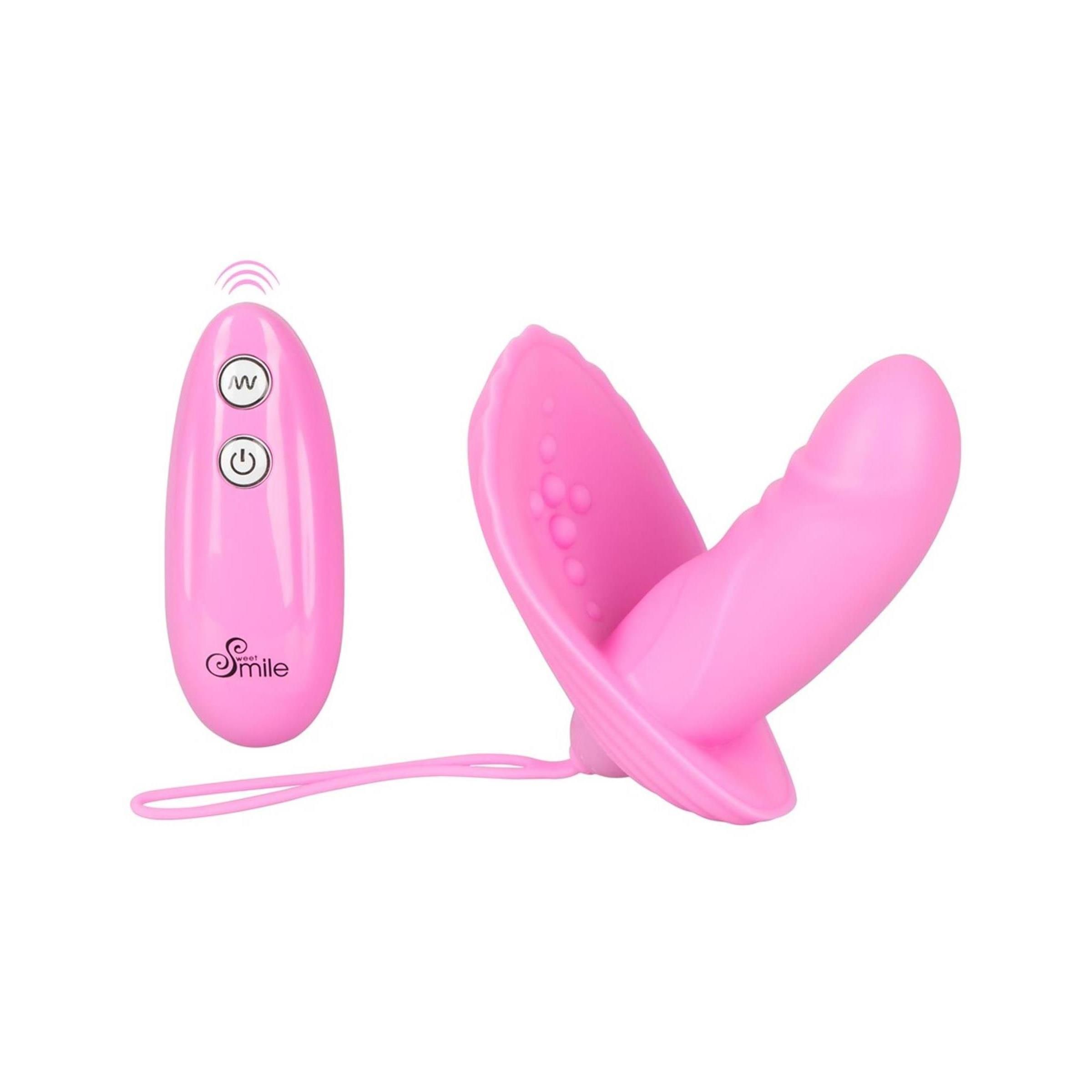 Rosa Vibrator mit Fernbedienung. Vibrator mit zwei Teilen und Fernbedienung. Aufschrift: Smile. Funktionen: Vibration.