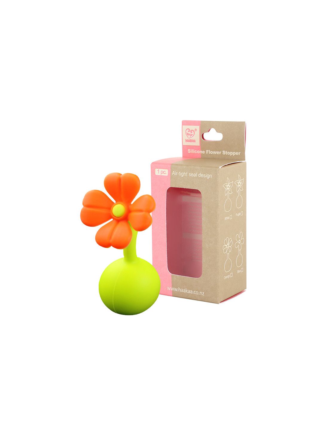 Blumenförmiger Verschluss neben Verpackung. Orangefarbene Blüte, grüner Stiel, braune Schachtel mit Text und Logo.
