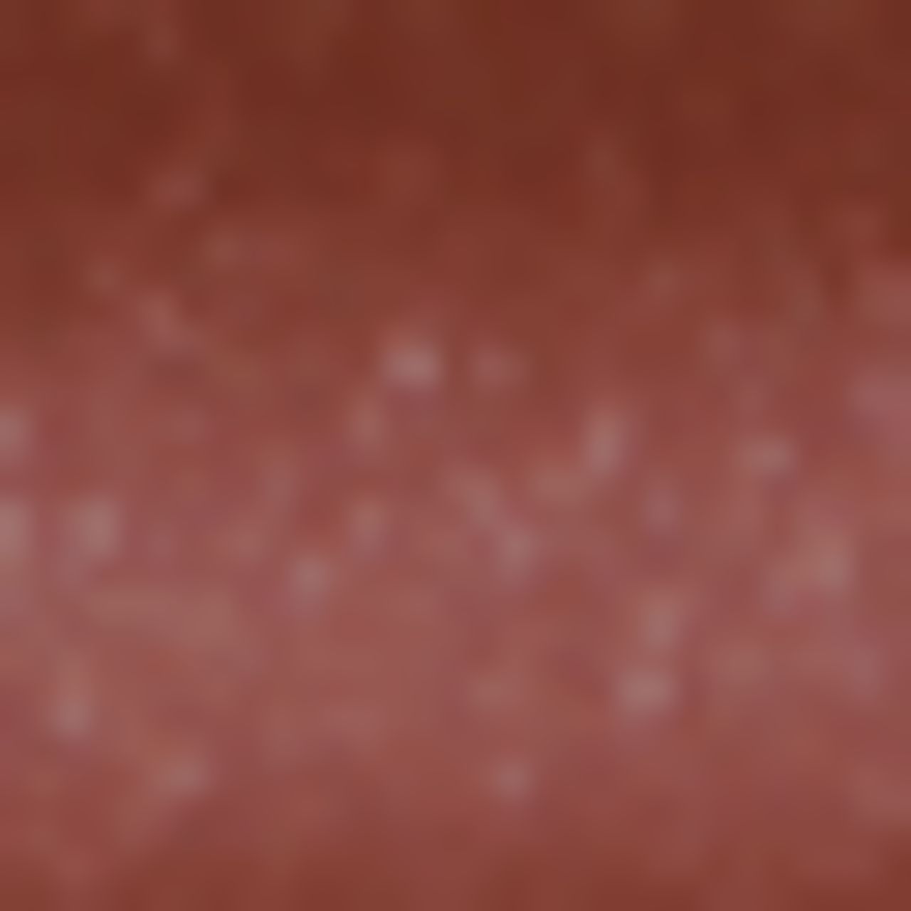 Verschwommene Nahaufnahme einer roten Oberfläche. Textur nicht erkennbar.