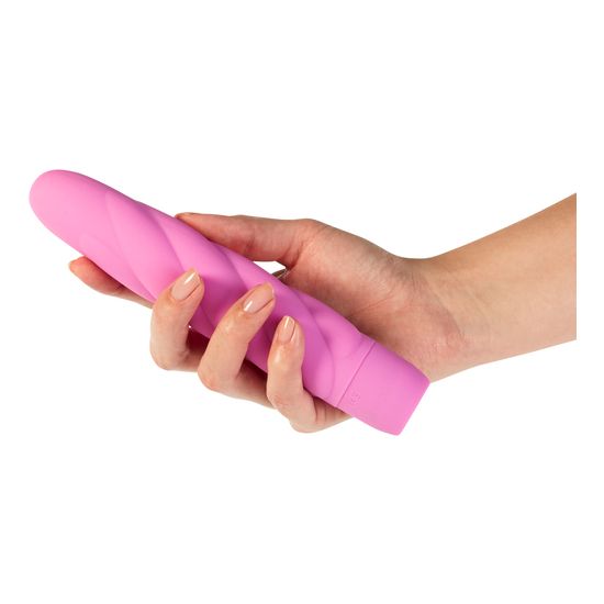 Rosa Vibrator in einer Hand gehalten. Die gedrehte Form ist deutlich zu erkennen.