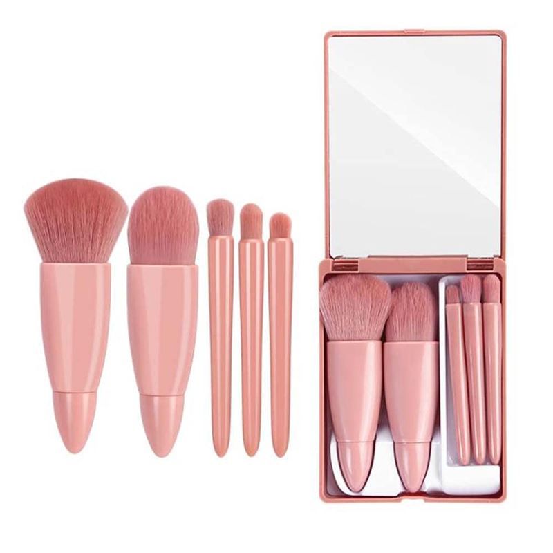 Rosa Reise-Makeup-Pinselset mit Spiegel. Enthält fünf Pinsel und eine rechteckige, aufklappbare Hülle mit Spiegel.