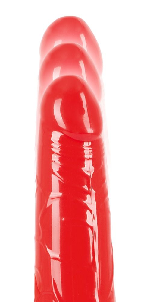 Roter Vibrator, Nahaufnahme. Drei Vibratoren in einer Reihe, leicht verschwommen.