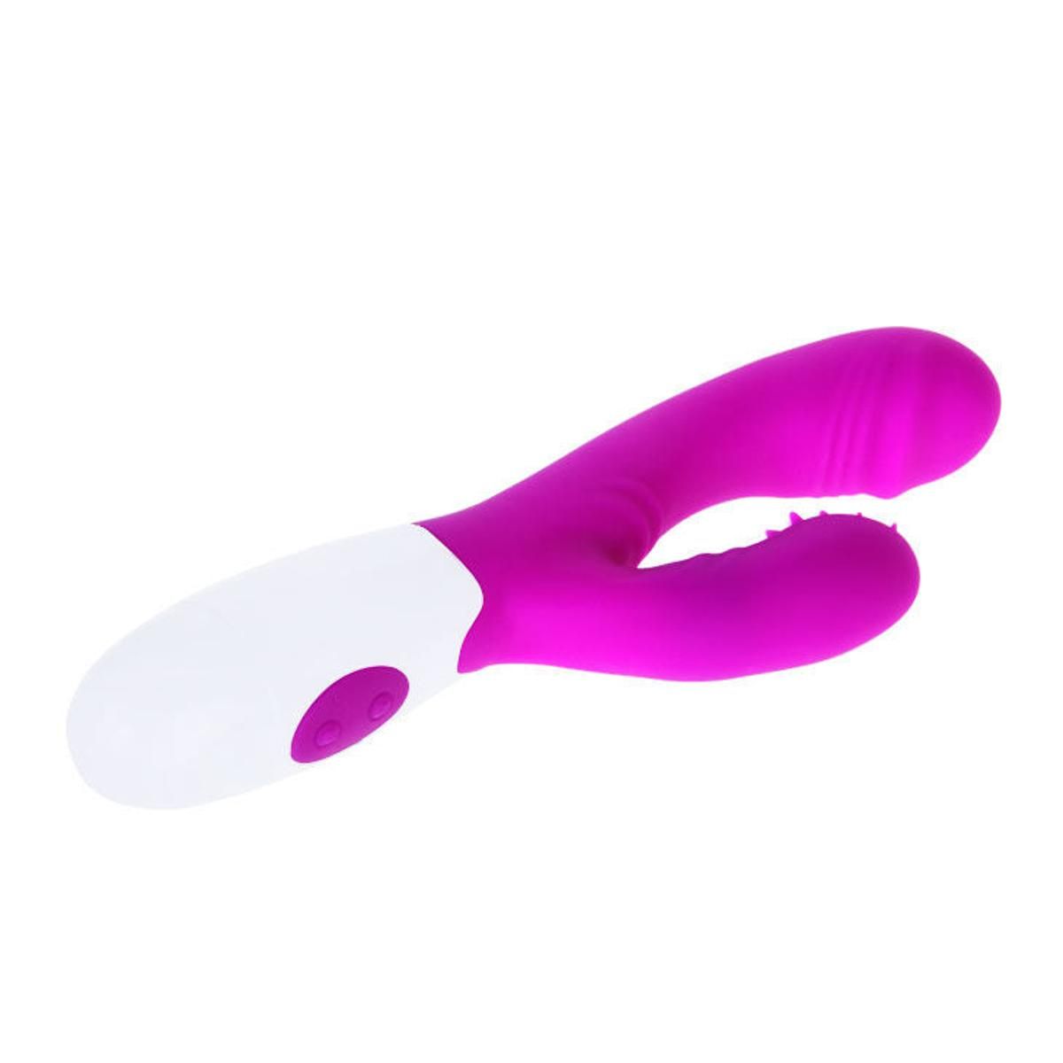 Lila-weißer Vibrator mit gebogener Form. Zwei Knöpfe am weißen Griff. Oberteil mit Noppen.