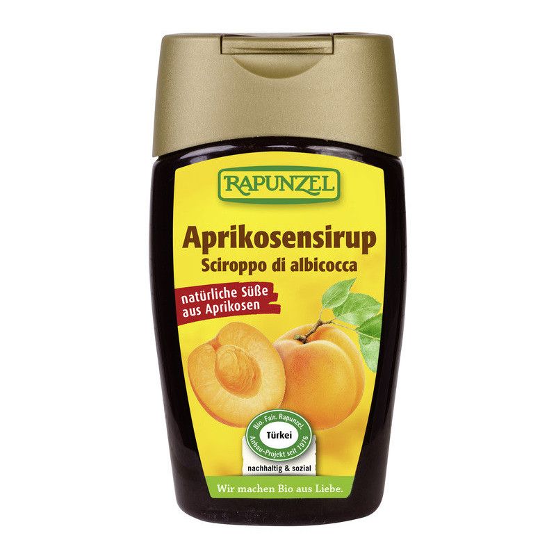 Braune Flasche mit gelbem Etikett. Aufschrift: Rapunzel Aprikosensirup, Sciroppo di albicocca. Abbildung von Aprikosen. Bio-Siegel.