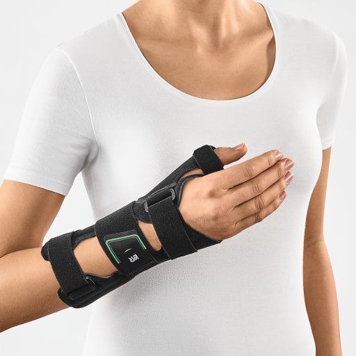 Schwarze Handgelenk-Daumen-Orthese mit Klettverschlüssen und grünen Akzenten. Stützt Handgelenk und Daumen.