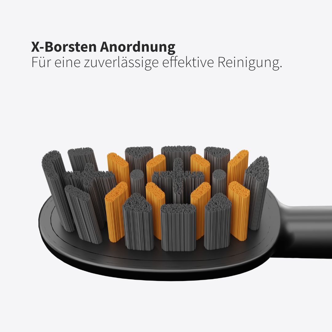 Nahaufnahme eines schwarzen Bürstenkopfes mit grauen und orangenen Borsten. X-Borsten Anordnung für effektive Reinigung.