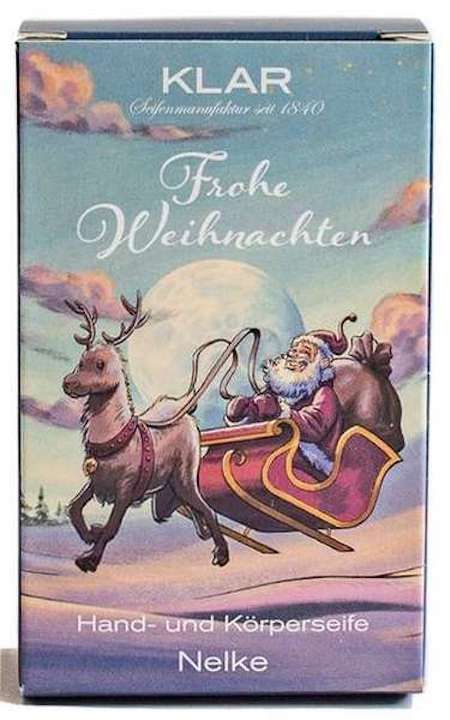 Klar-Seifen-Verpackung. Motiv: Weihnachtsmann im Schlitten, Rentier. Text: Frohe Weihnachten, Nelke, Hand- und Körperseife.
