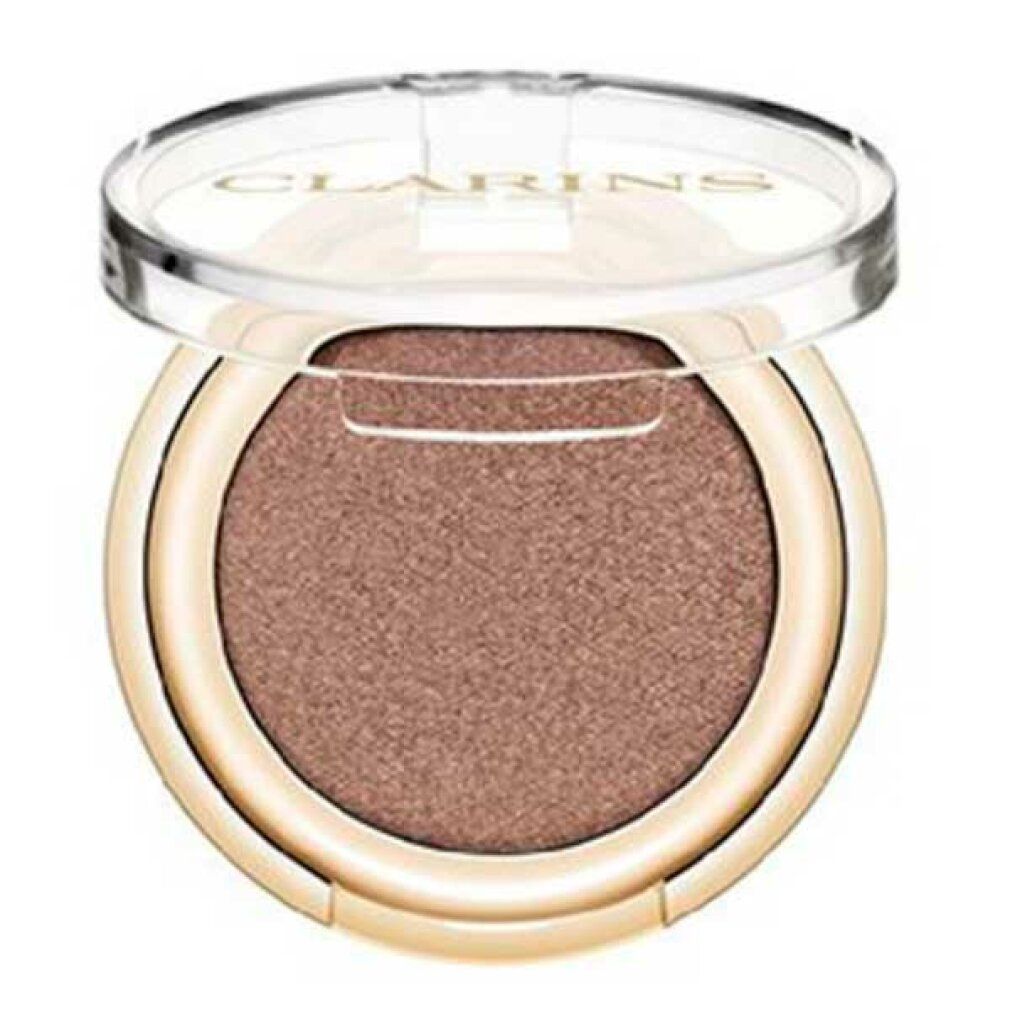 Runder Lidschatten-Compact mit goldfarbenem Rand und geöffnetem, transparentem Deckel. Taupefarbener Lidschatten.