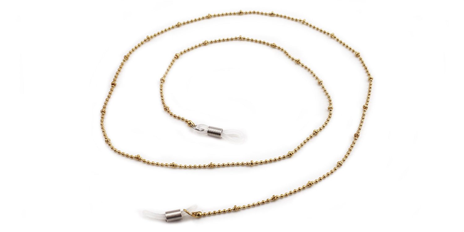 Brillenkette aus goldfarbenen Kugeln. An den Enden befinden sich transparente Silikon-Schlaufen zur Befestigung an Brillenbügeln.