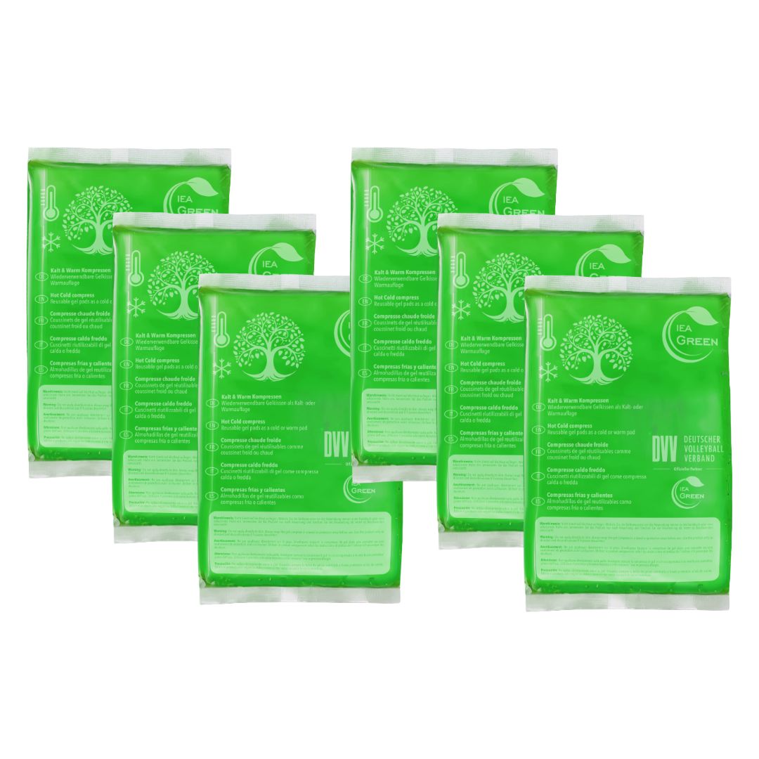 Sieben grüne Kompressen-Verpackungen. Aufdruck: IEA Green, Baum-Logo, DVV-Siegel. Einzelverpackung.