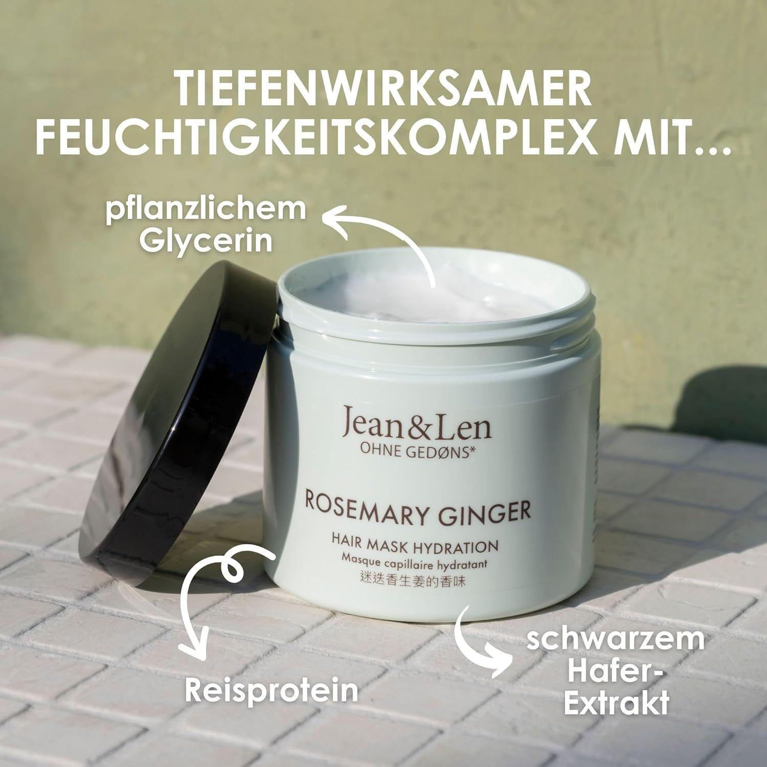 Offener Tiegel Jean & Len Rosemary Ginger Hair Mask. Text: Tiefenwirksamer Feuchtigkeitskomplex mit pflanzlichem Glycerin, Reisprotein, Schwarzem Hafer-Extrakt.