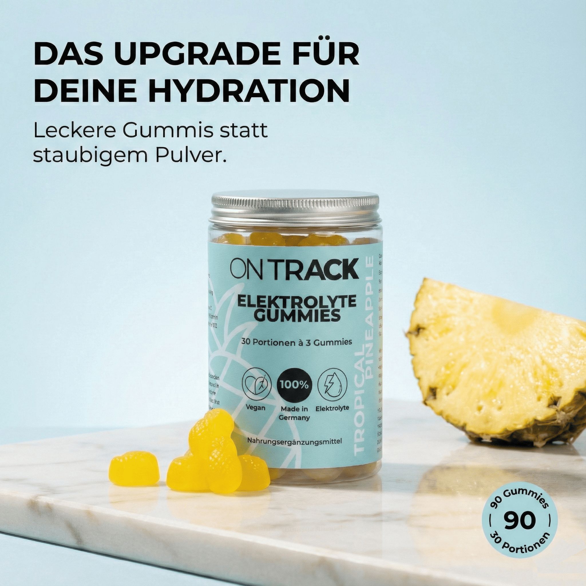 Glas mit Elektrolyte Gummies, Ananas-Stück. Aufschrift: OnTrack, Elektrolyte Gummies, 30 Portionen, 3 Gummies. Vegan, 100%, Made in Germany.