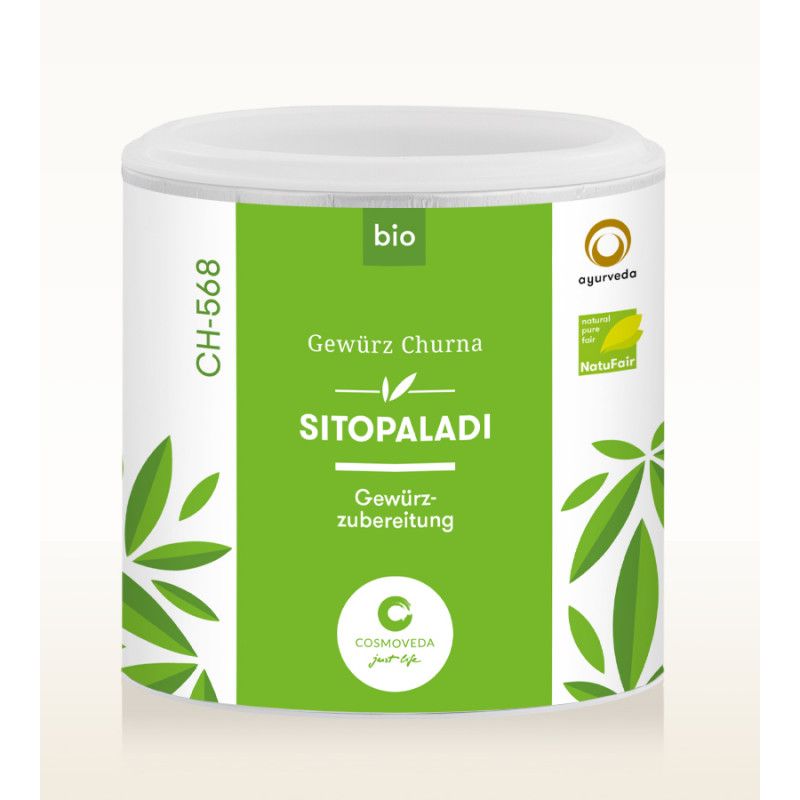 Weißes Dose mit "Sitopaladi Churna". Grün-weißes Etikett mit Text und Blättern. Bio-Siegel und NaturFair-Logo.