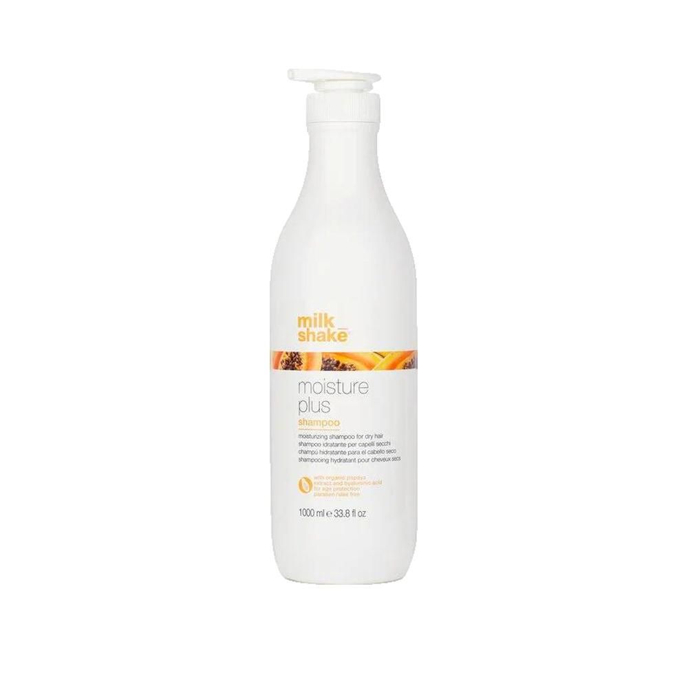 Weiße Flasche mit Pumpe. Aufschrift: milk_shake, moisture plus shampoo. Orangefarbener Streifen mit Papaya-Abbildung. 1000 ml.