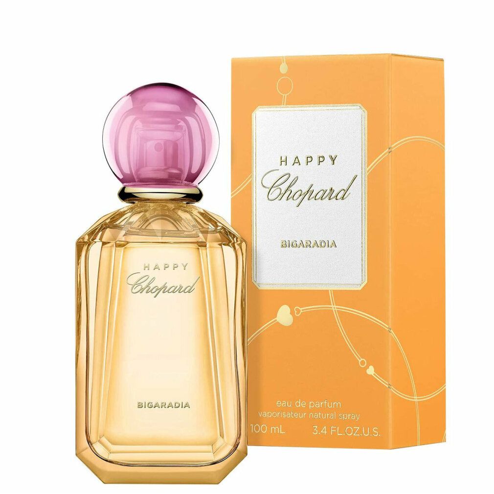 Parfümflasche und Verpackung. Aufschrift: Happy Chopard Bigaradia. Flasche mit rosa Verschluss. Orangefarbene Verpackung.