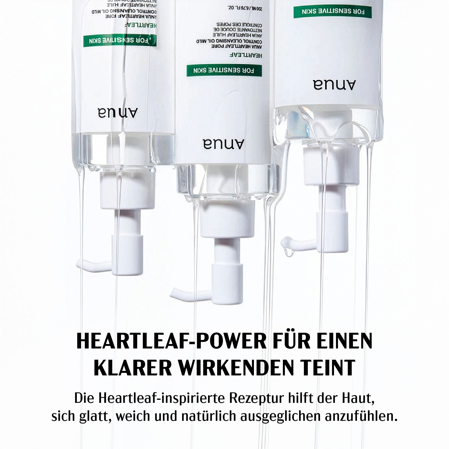 Drei weiße Flaschen mit Pumpen, Öl fließt. Text: Anua, FOR SENSITIVE SKIN, HEARTLEAF PORE CONTROL CLEANSING OIL MILD.