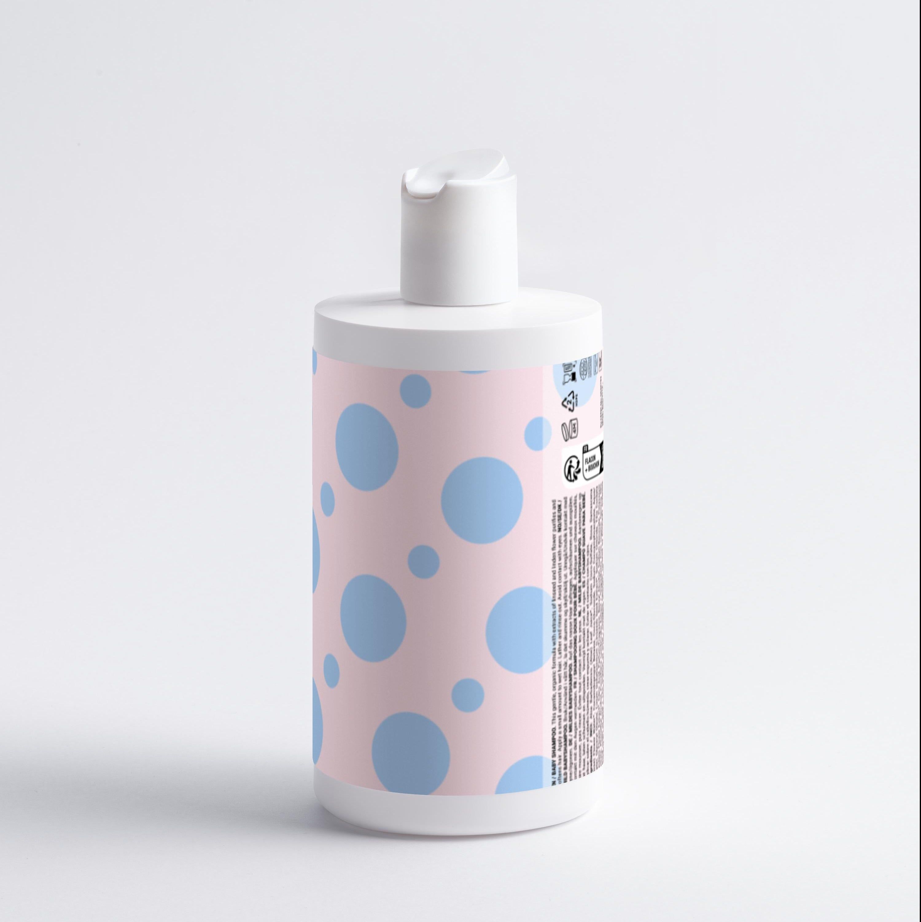 Rückseite einer Baby-Shampoo-Flasche. Weiße Flasche mit rosa Etikett und blauen Punkten. Text und Symbole.