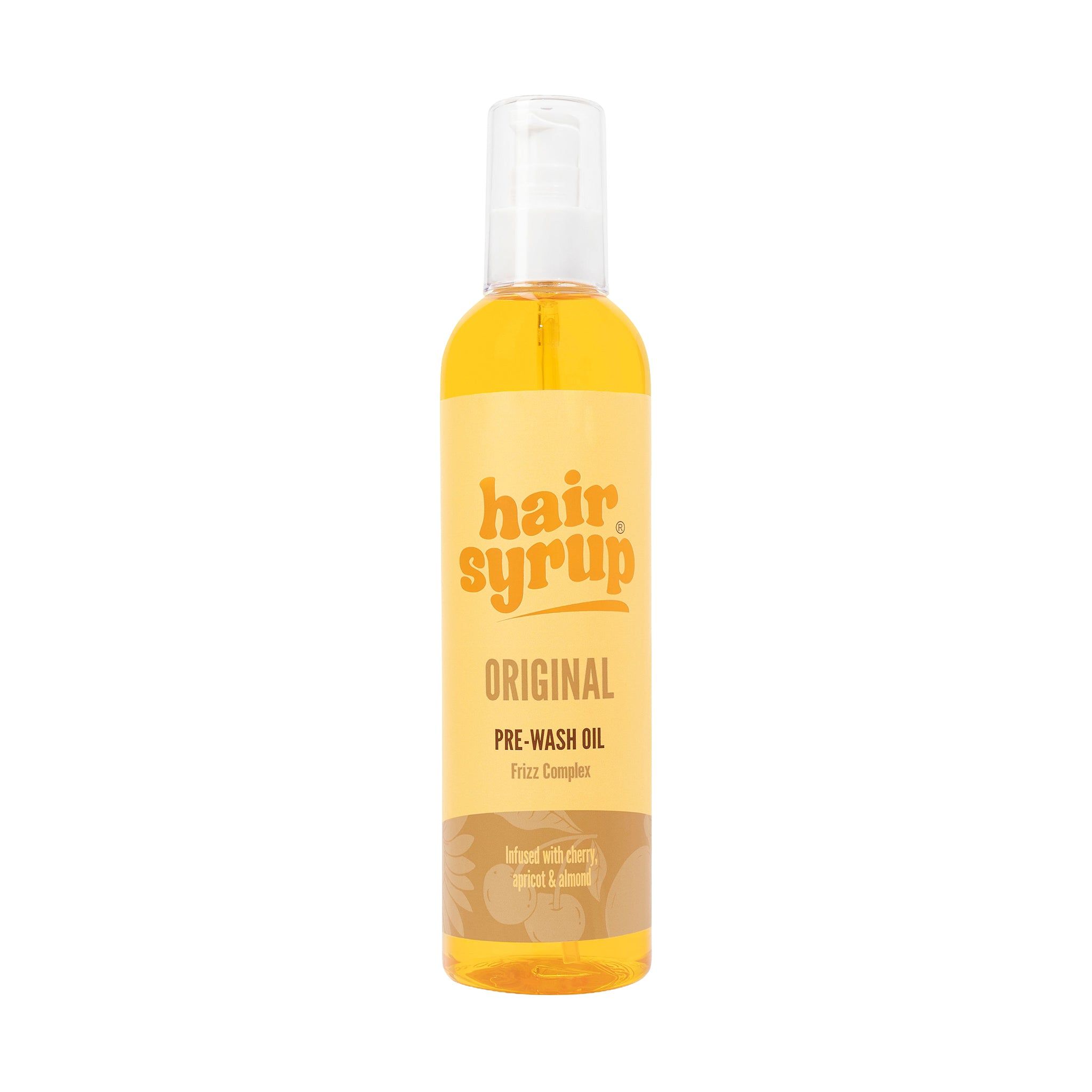 Hair Syrup Original Flasche. Aufschrift: Pre-Wash Oil. Auf gelbem Hintergrund.