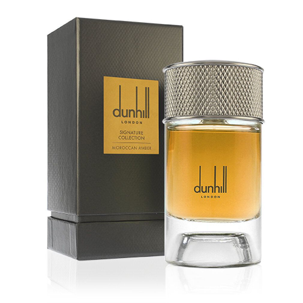 Flacone di profumo e scatola. Flacone con tappo argentato, liquido dorato. Scatola nera con etichetta dorata.