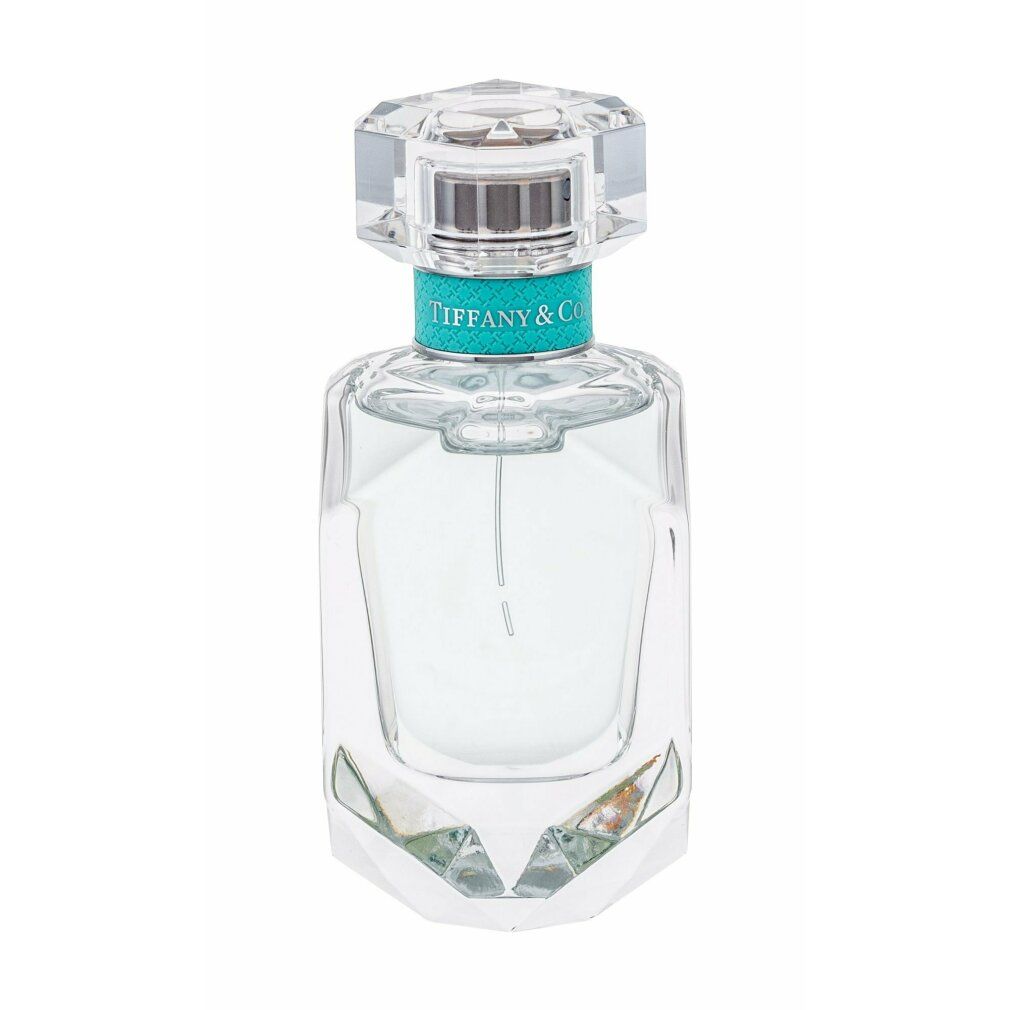 Glasflakon mit transparentem Inhalt, eckiger Form und Kristallverschluss. Türkisfarbener Ring mit Tiffany & Co. Schriftzug.