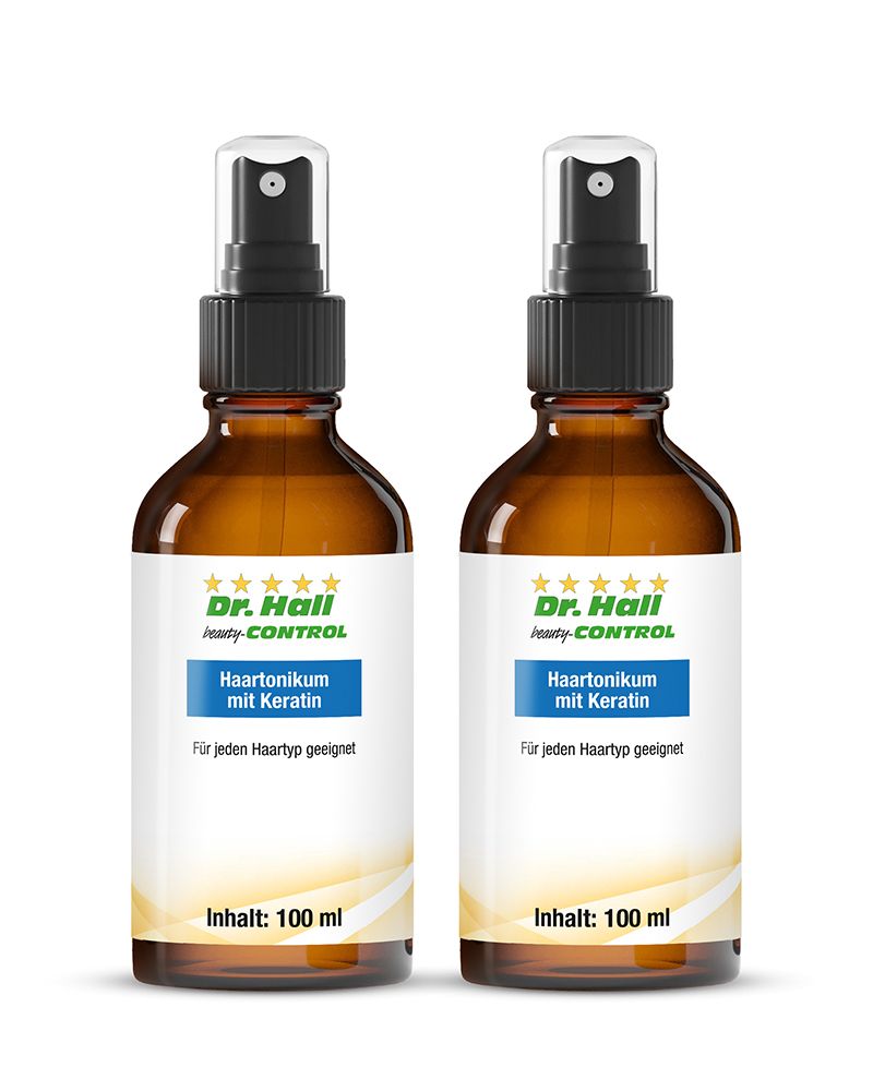 Zwei braune Flaschen mit Sprühkopf. Auf den Etiketten steht "Dr. Hall Haartonikum mit Keratin".