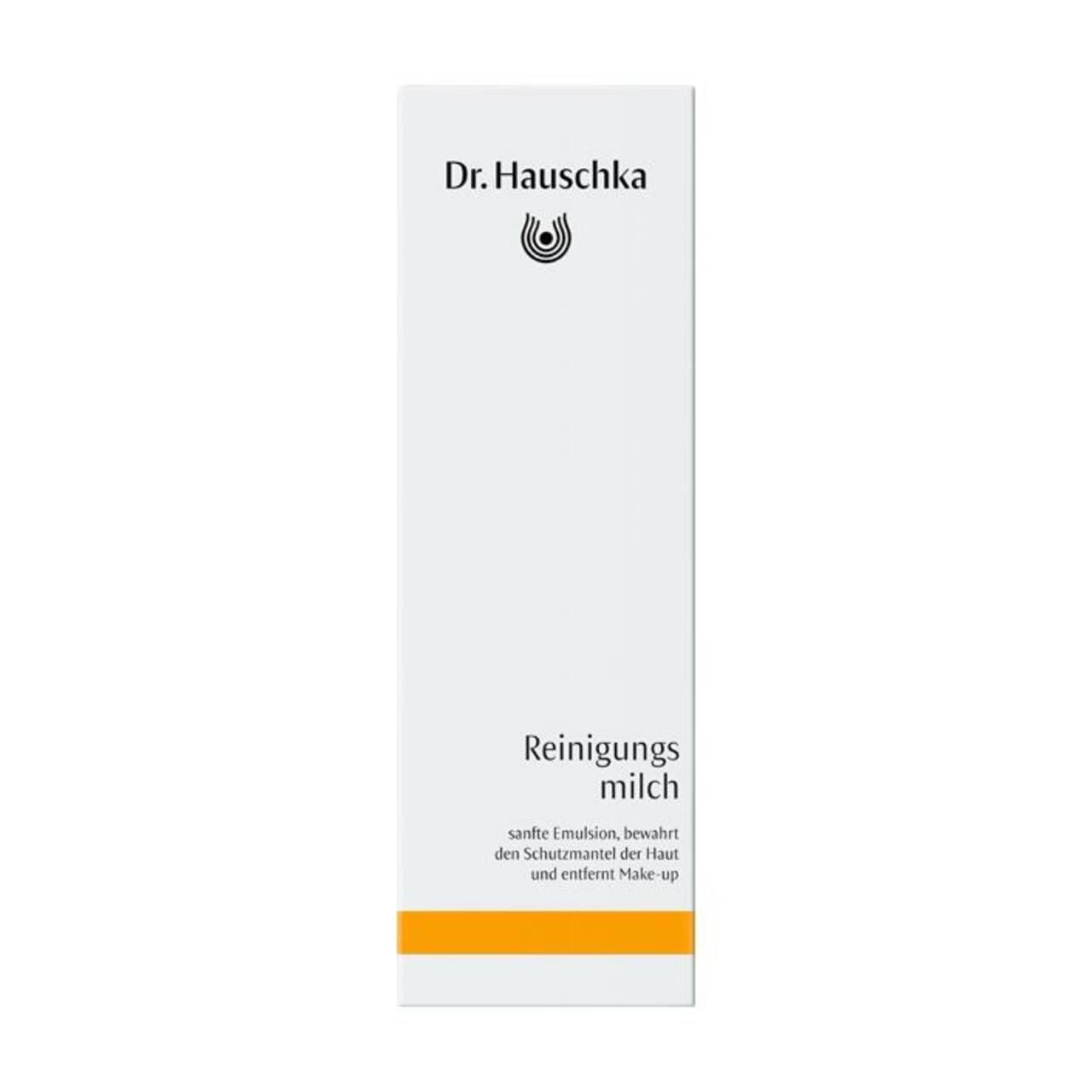 Dr. Hauschka Reinigungsmilch Verpackung. Weißer Karton mit Produktnamen und Logo. Orangefarbener Streifen.