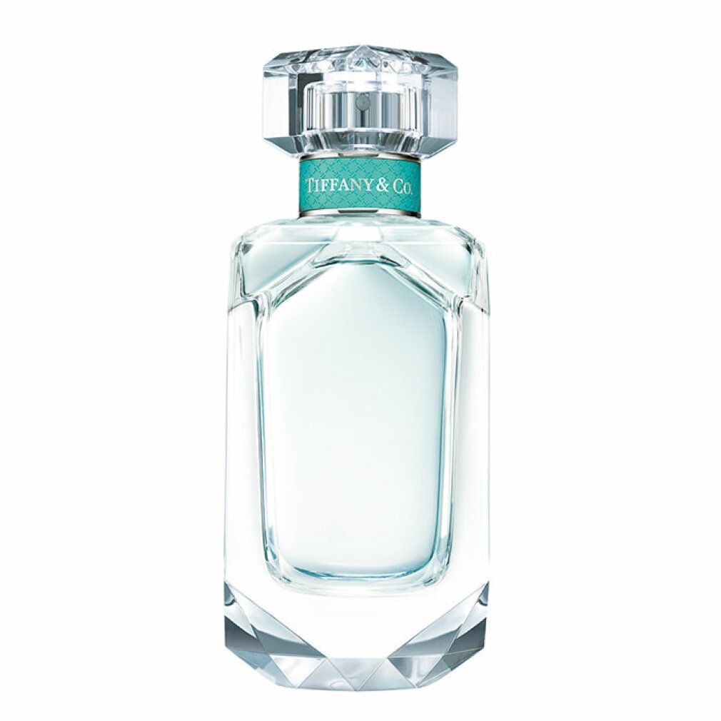 Glasflakon mit transparentem Inhalt, eckiger Form und Kristallverschluss. Türkisfarbener Ring mit Tiffany & Co. Schriftzug.