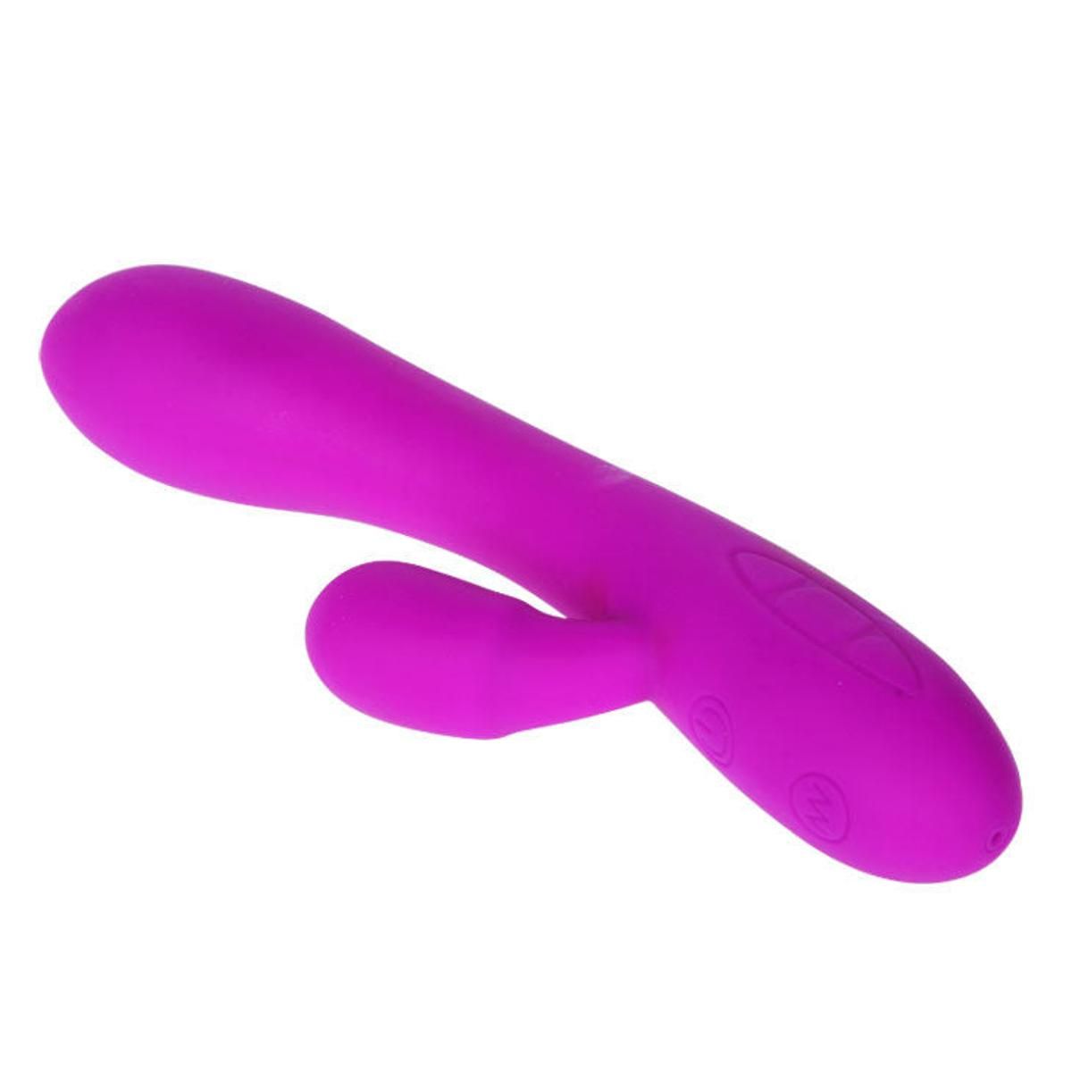 Lila Vibrator mit gebogener Form und einem kleineren, hervorstehenden Teil. Knöpfe an der Basis.