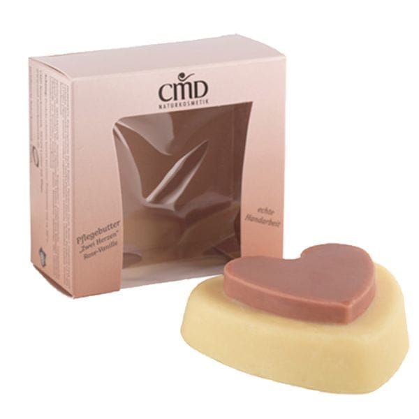 Pflegebutter in Herzform, mit einem kleineren Herz darauf. Verpackung mit Markennamen CMD Naturkosmetik.