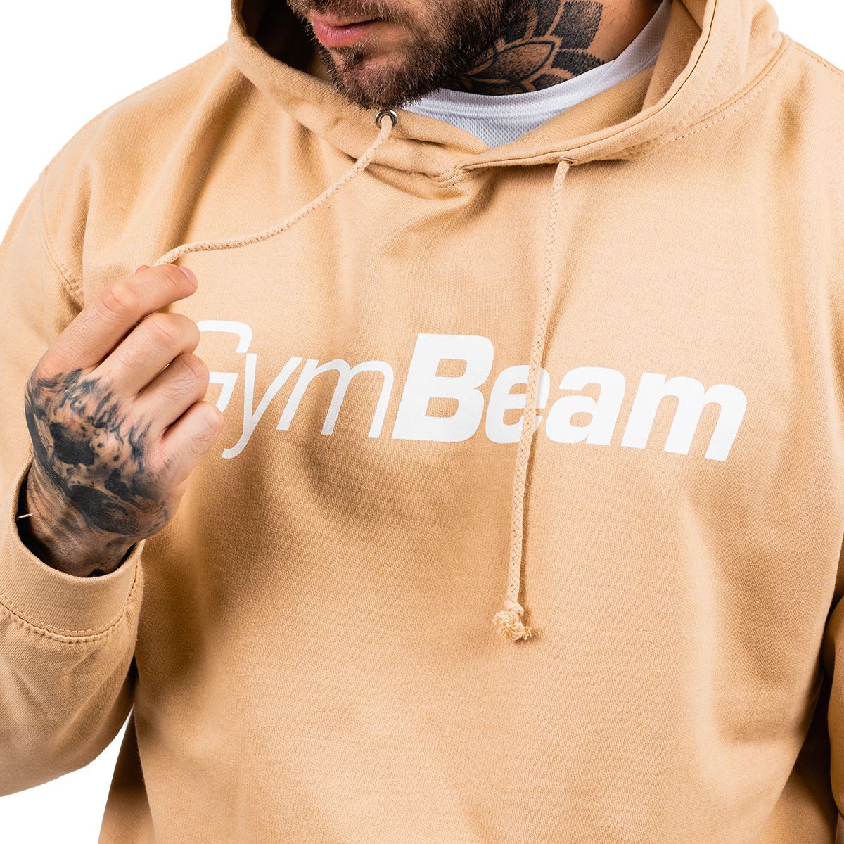 Nahaufnahme der Kordelzüge und des weißen GymBeam Logos auf einem sandfarbenen Hoodie.