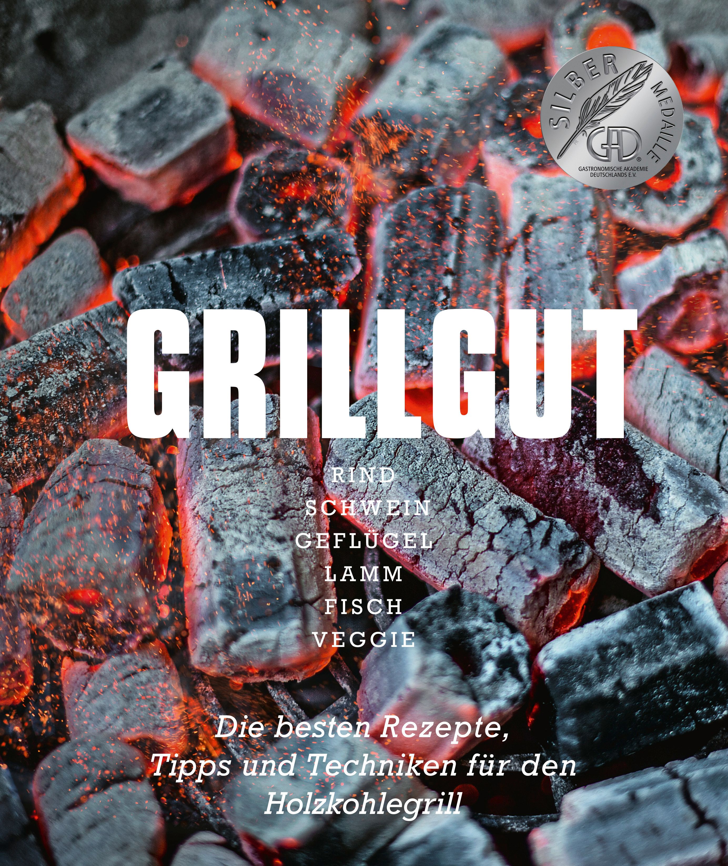 Buchcover mit Grillgut-Titel, Zutatenliste und Auszeichnung. Auf Holzkohle-Hintergrund.