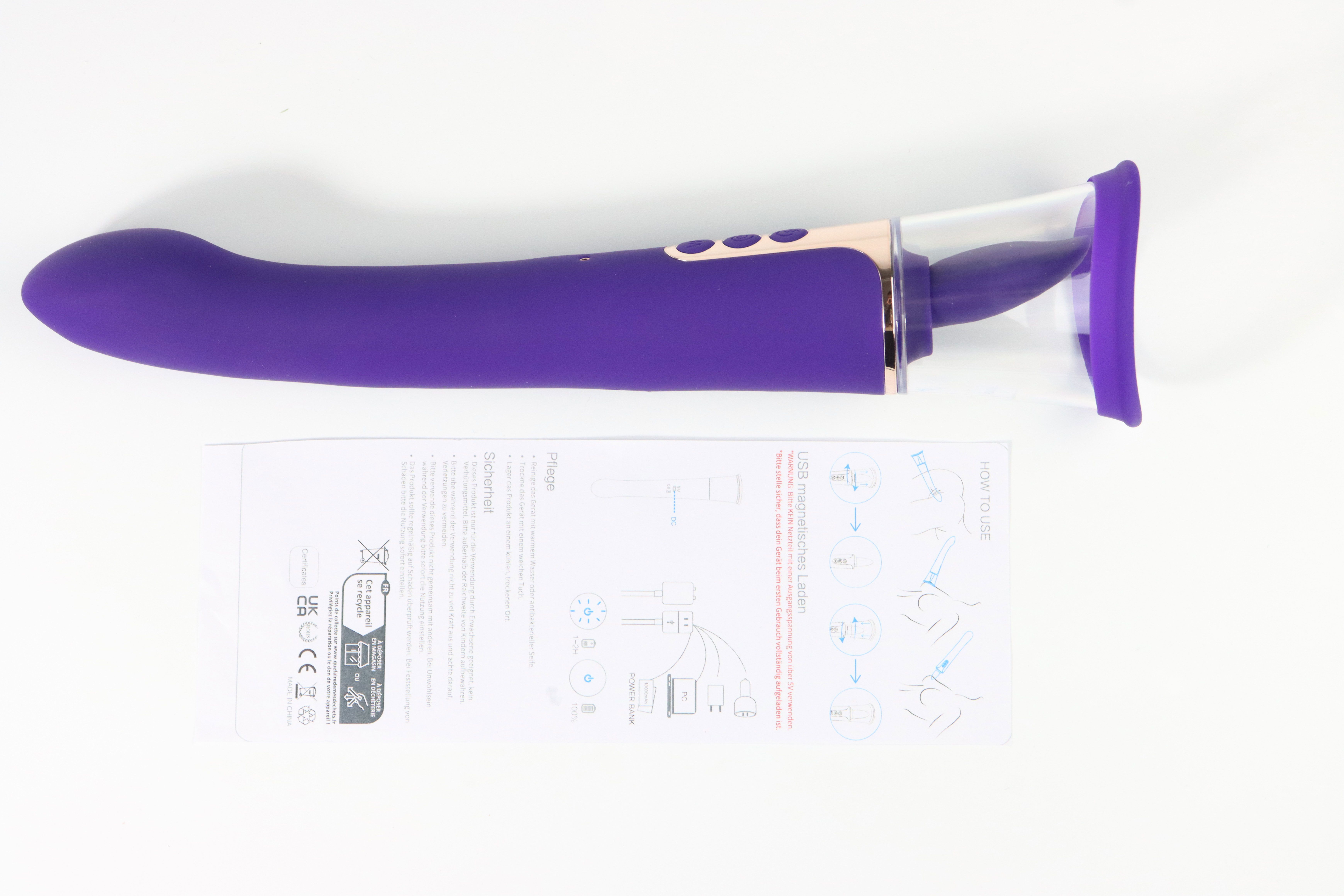 Lila Vibrator mit Bedienungsanleitung. Transparenter Aufsatz. Drei Knöpfe.