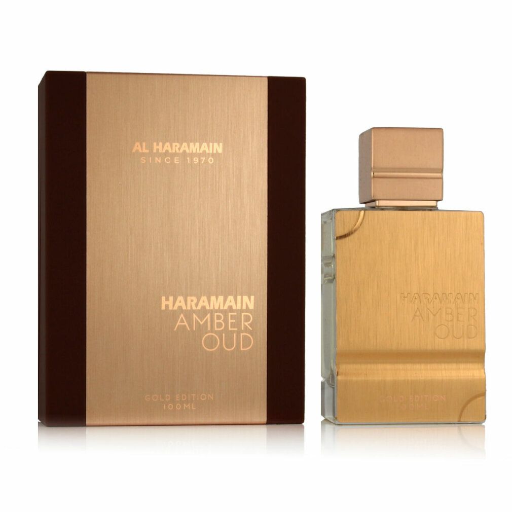 Goldfarbener Flakon und Verpackung. Aufschrift: HARAMAIN AMBER OUD. Braune Verpackung mit goldfarbener Front. Flakon mit goldfarbenem Deckel.