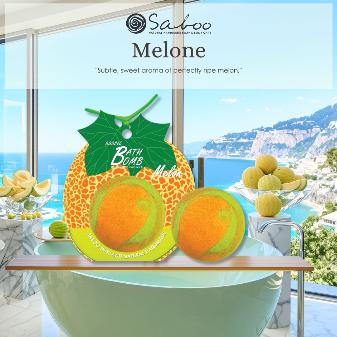 Zwei Schaumbad-Bomben mit Melonen-Design. Eine auf einem Tisch, eine im Hintergrund. Meerblick. Text: Melone, Saboo.