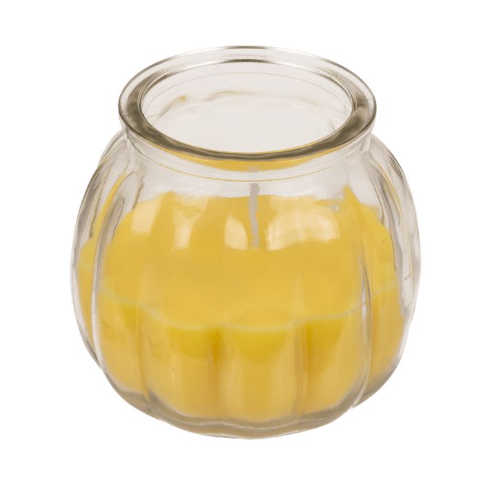 Gele kaars in glas. Gegolfde vorm. Transparante glazen pot. Lont zichtbaar.