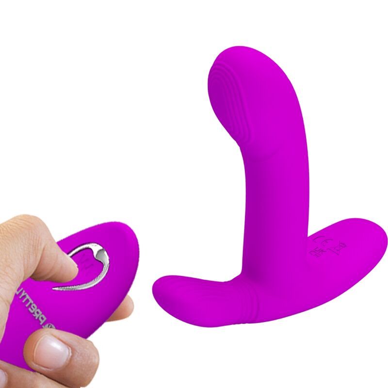 Lila Vibrator mit Fernbedienung. Hand hält Fernbedienung mit Knopf.
