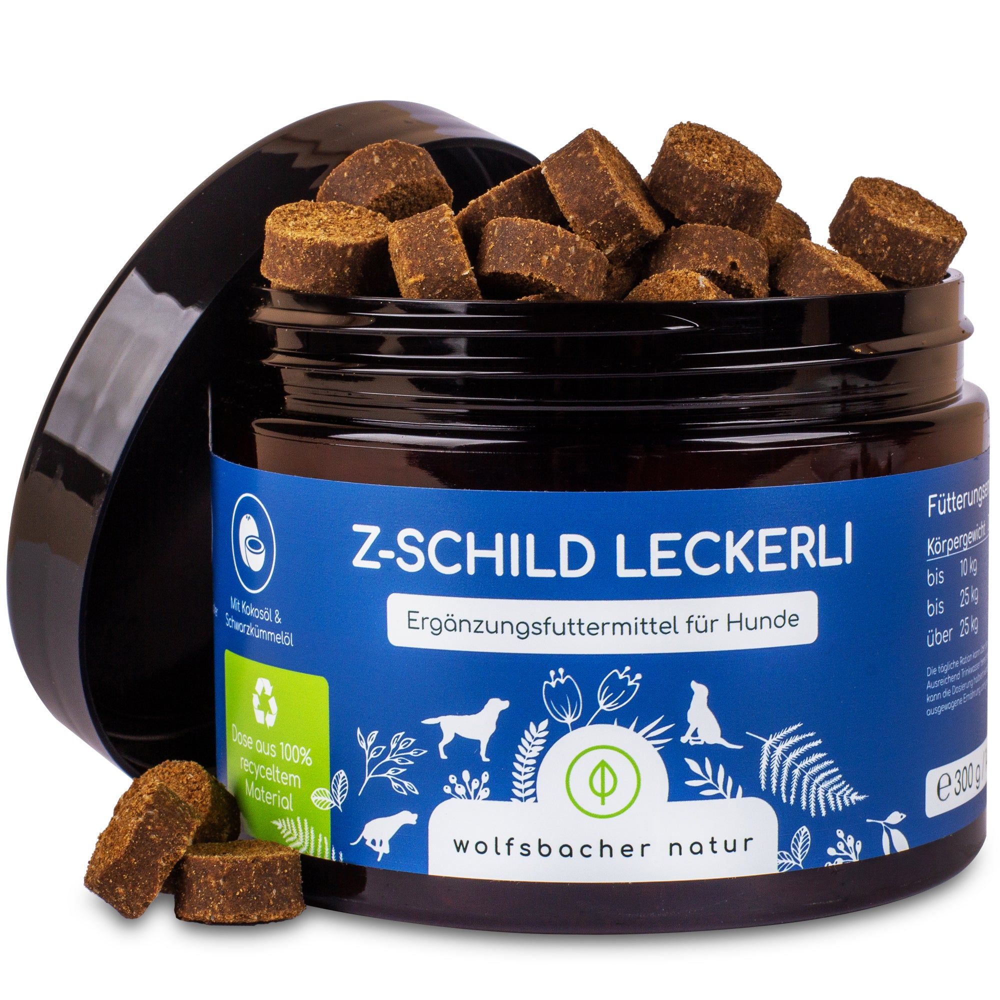 Dose mit Z-Schild Leckerli für Hunde. Braune, quadratische Snacks. Schwarzer Deckel. Blaue Etikett mit Text und Logo.