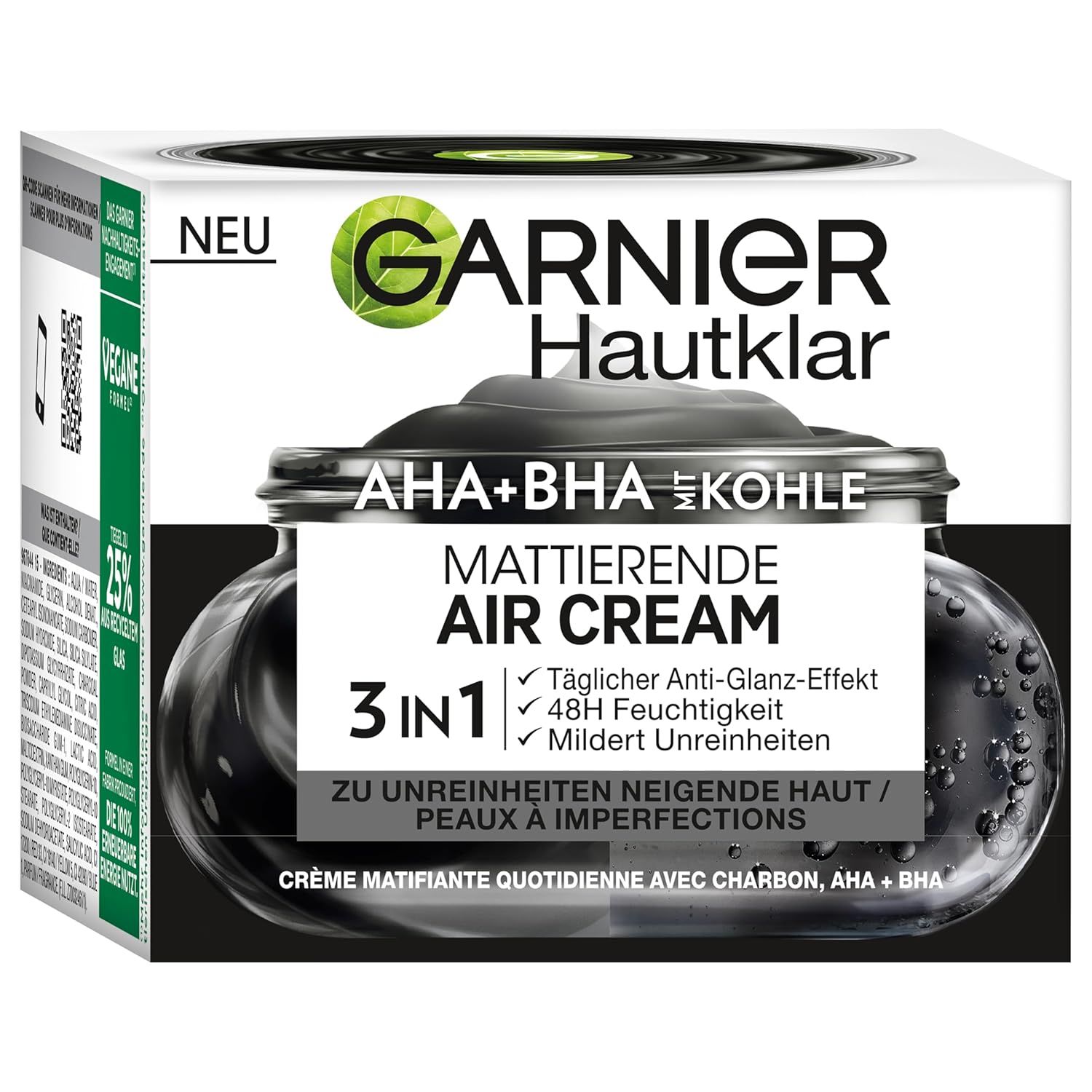 Garnier Hautklar Creme-Verpackung. Schwarze Creme im Glas, weißer Karton mit Produktinformationen und Logo.