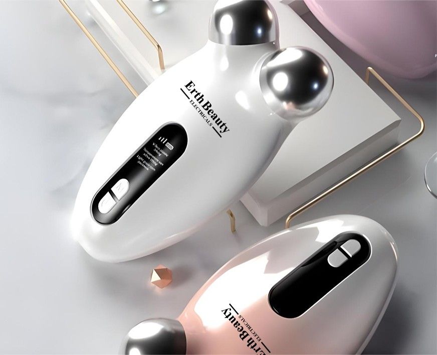 Zwei weiße Gesichtslifting-Geräte mit Metallkugeln. Auf einem Gerät: Erth Beauty Electricals. Auf dem anderen: Erth Beauty Electricals.