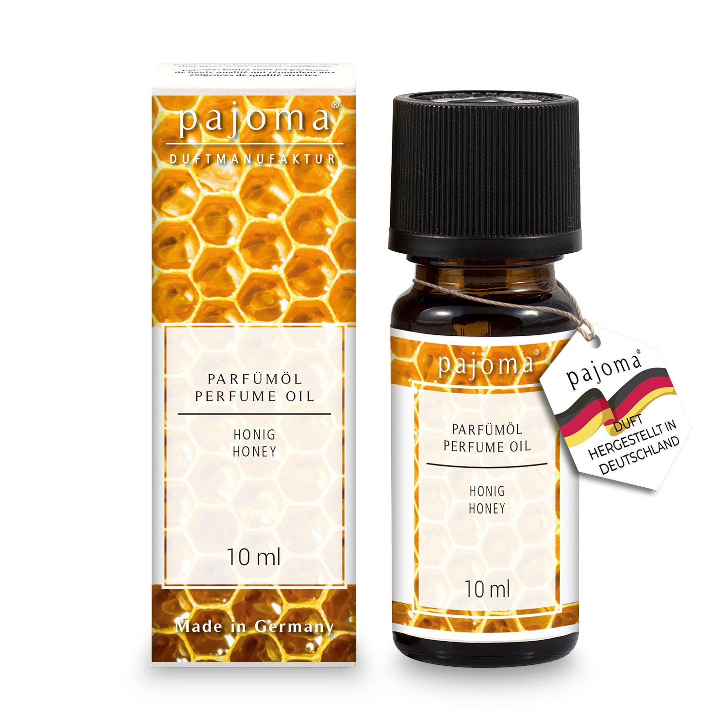 Braune Glasflasche mit schwarzem Deckel und Etikett. Aufschrift: Honig. Karton mit Honigwabenmuster und Produktinformationen.