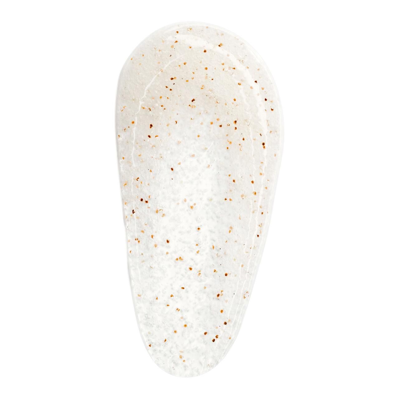 Auslauf von Körperpeeling. Weiße Basis mit braunen Partikeln.