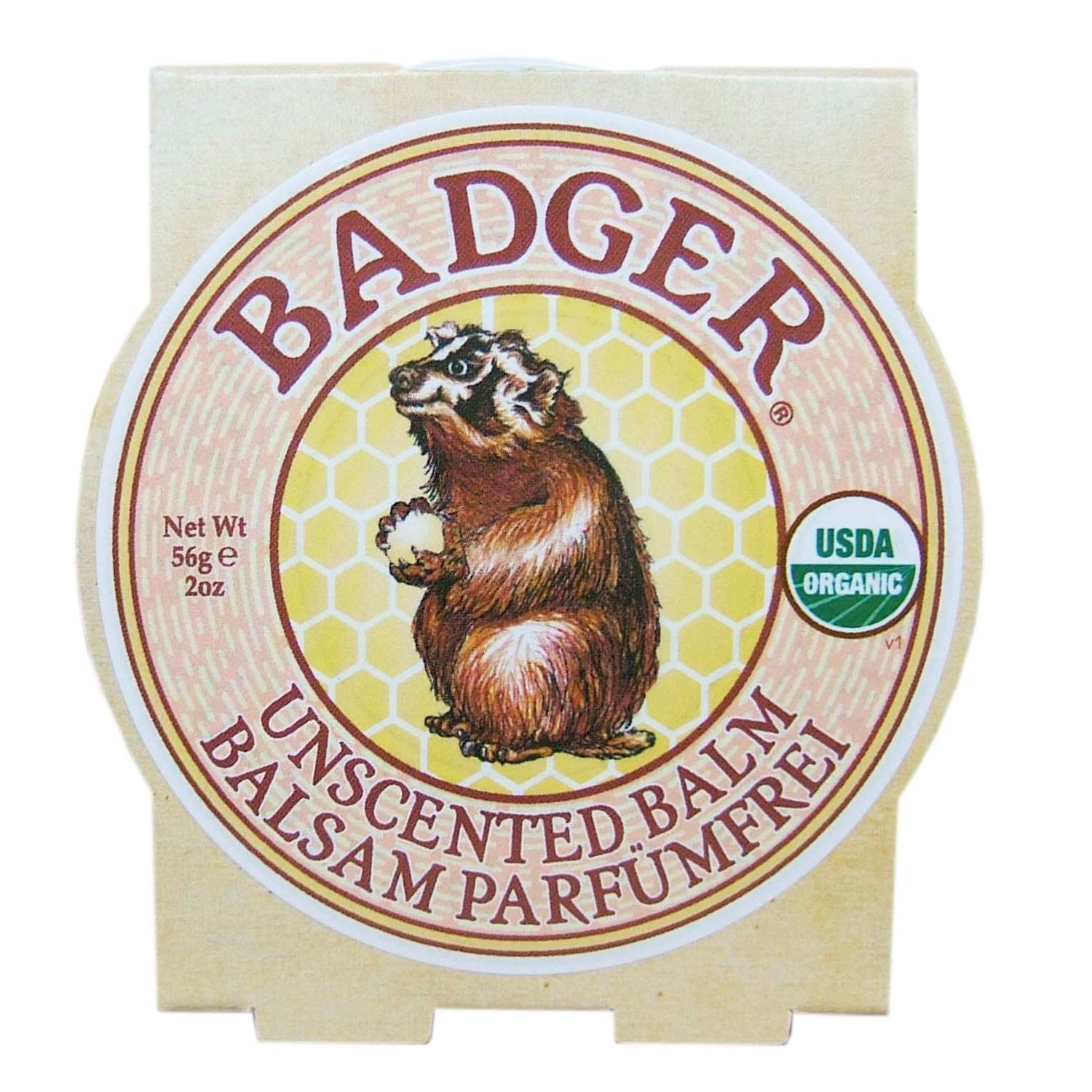 Runde Verpackung mit Label. Label zeigt Dachs, Text: BADGER, UNSCENTED BALM, PARFUMFREI. USDA Organic Siegel.