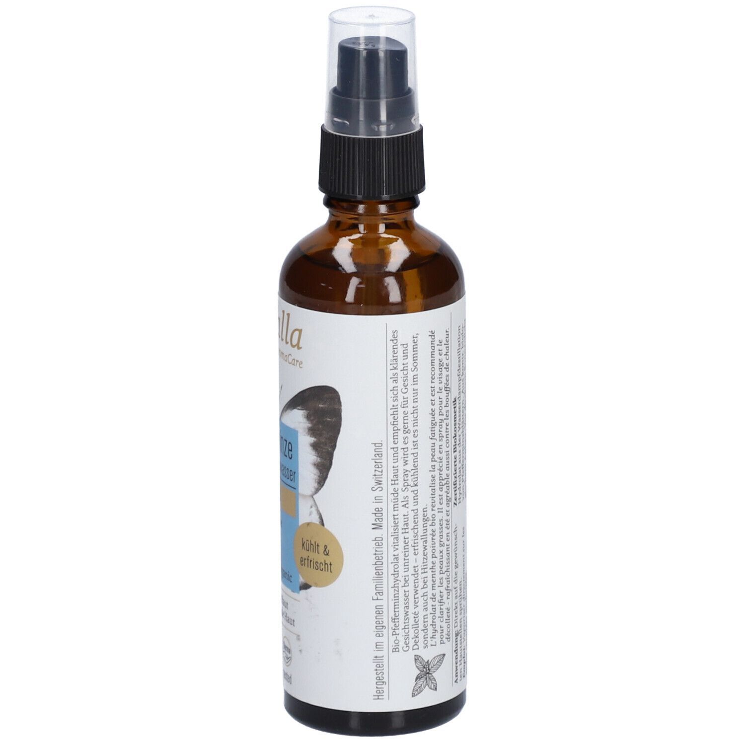 Braune Glasflasche mit Sprühkopf. Etikett mit Produktinformationen und Text. Herstellungs- und Haltbarkeitsangaben.