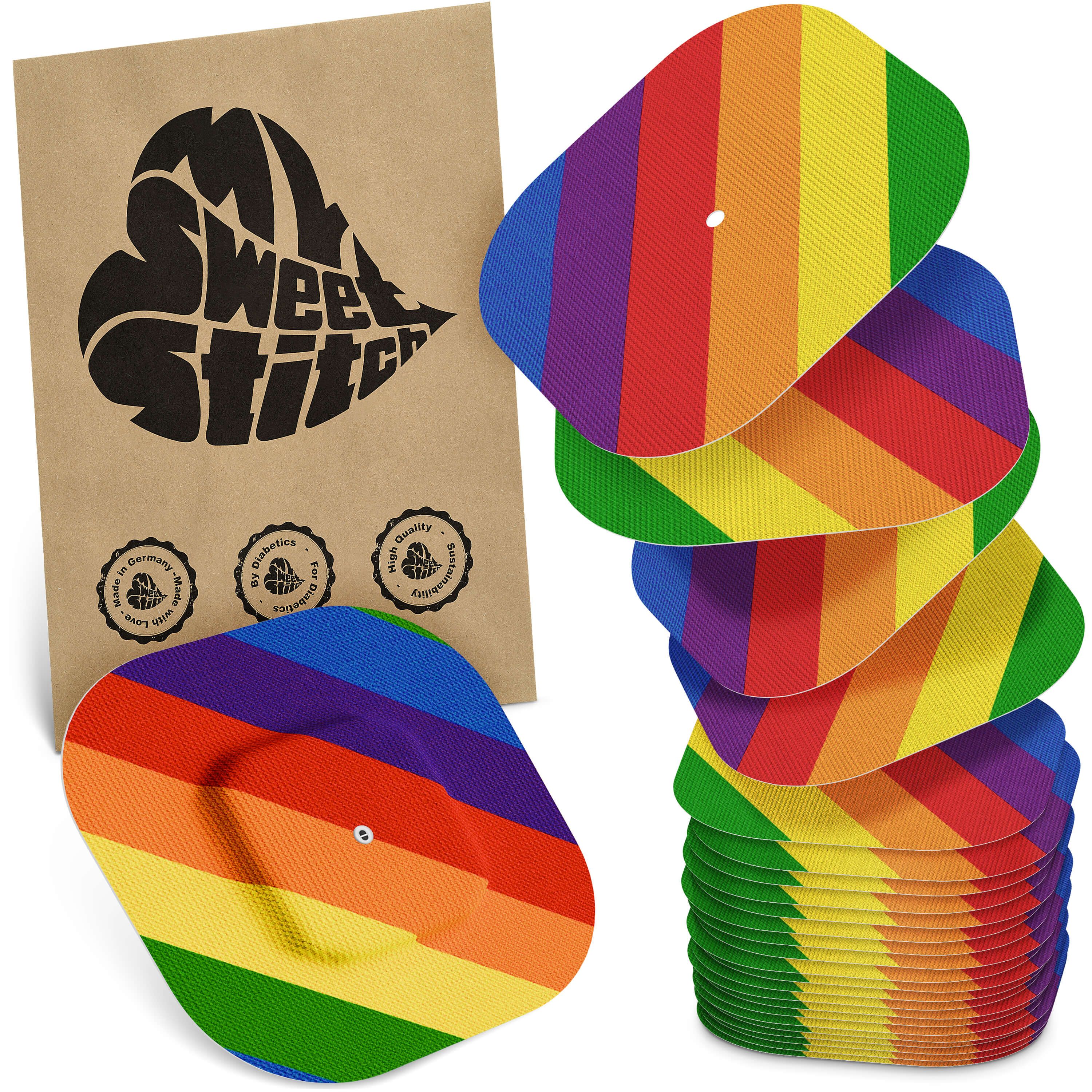 Mehrfarbige Pflaster mit Regenbogenmuster. Braune Verpackung mit Logo MySweetStitch. Stapel von Pflastern, einige lose daneben.
