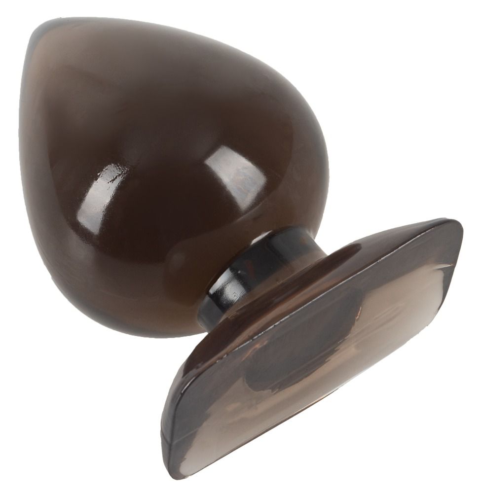 Analplug, braun getönt, Tropfenform. Spitze und Basis dunkler. Glatte Oberfläche. Breiter Basis. Liegt auf der Seite.