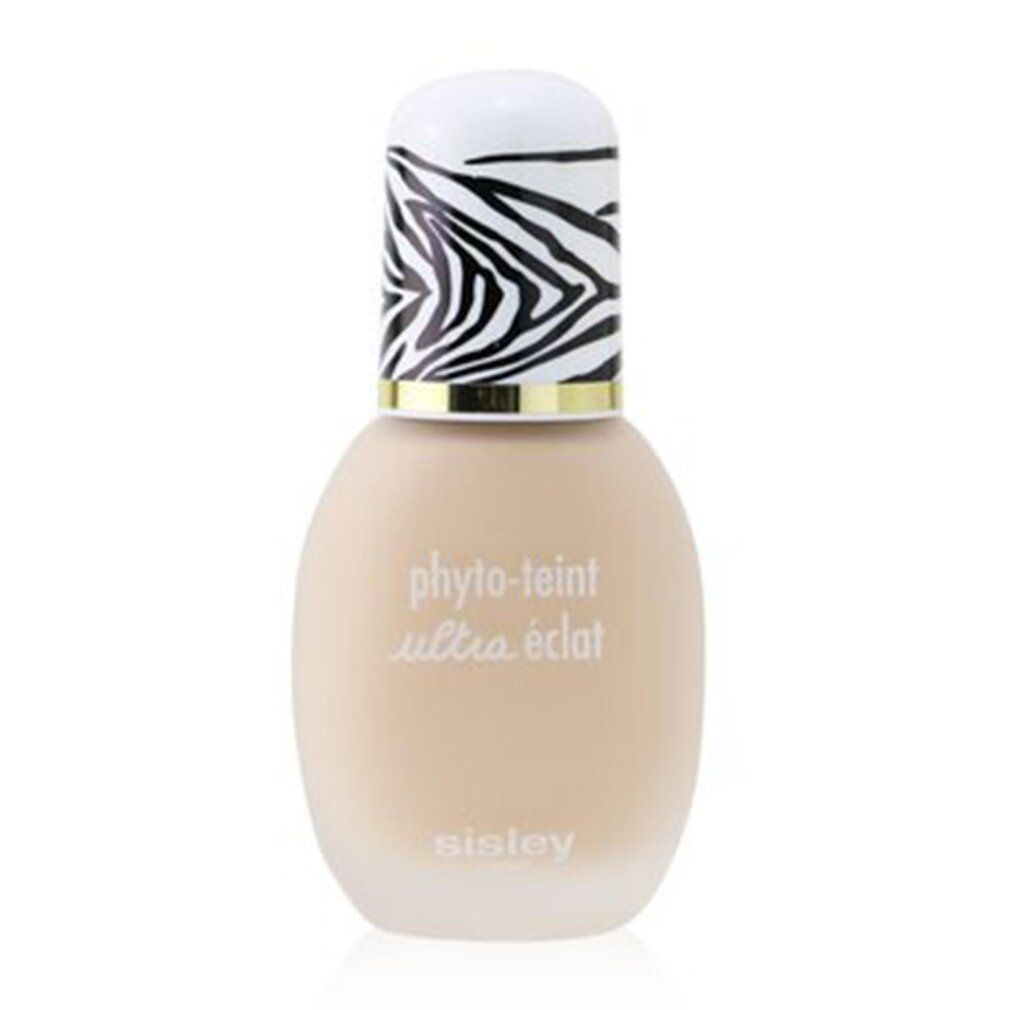 Flakon mit beigem Inhalt, weißem Deckel mit Zebra-Muster und goldenem Ring. Text: Phyto-Teint Ultra Éclat, Sisley.