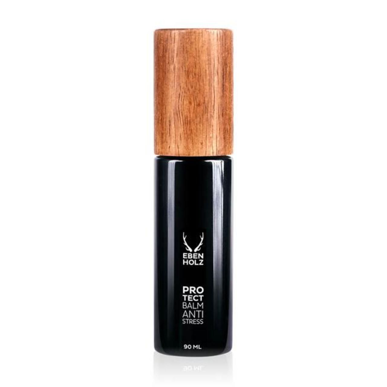 Schwarze Flasche mit Holzdeckel. Aufschrift: Ebenholz, Protect Balm Anti Stress. Unten: 90 ml.